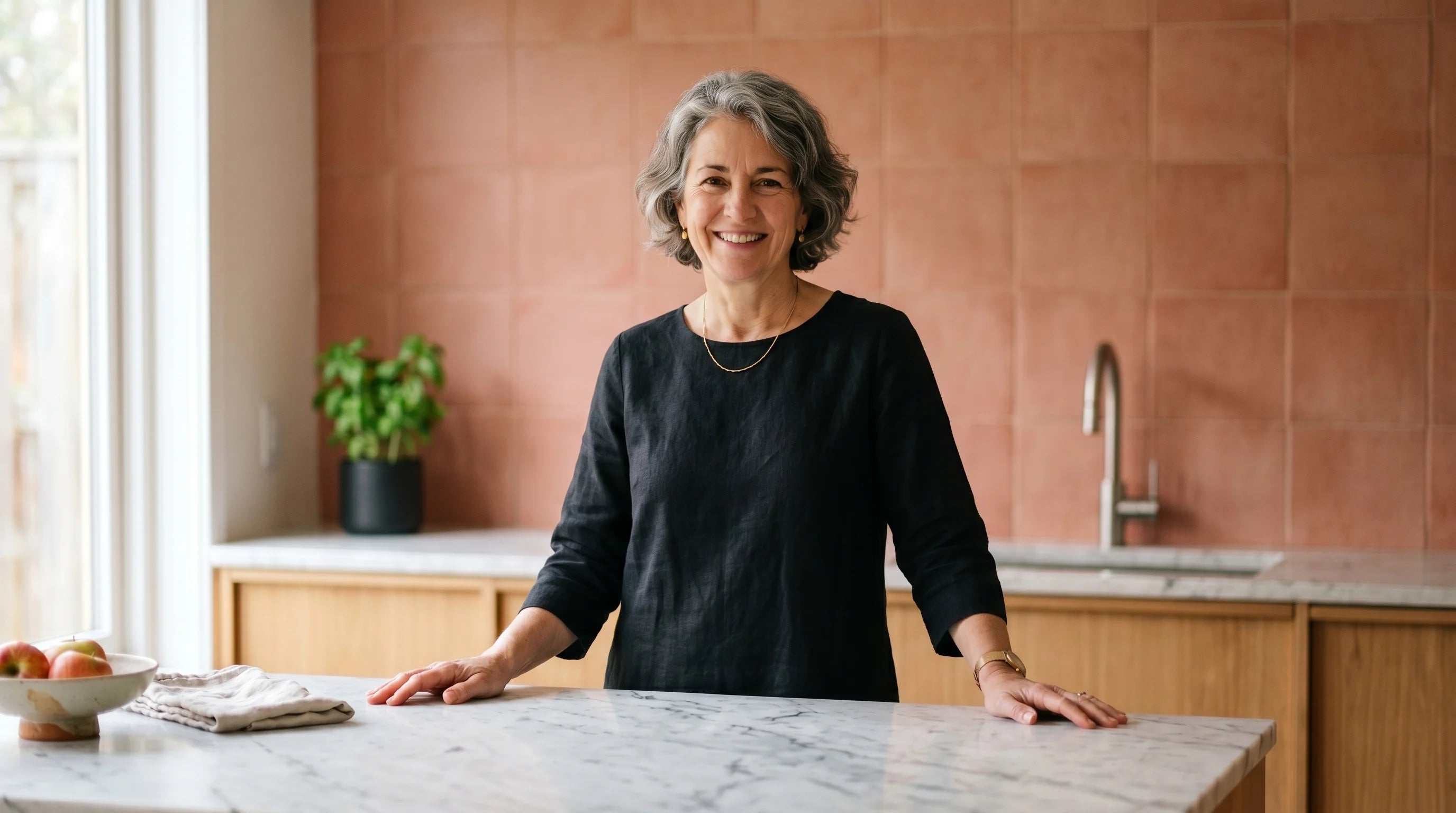 Woman smiling in a bright kitchen