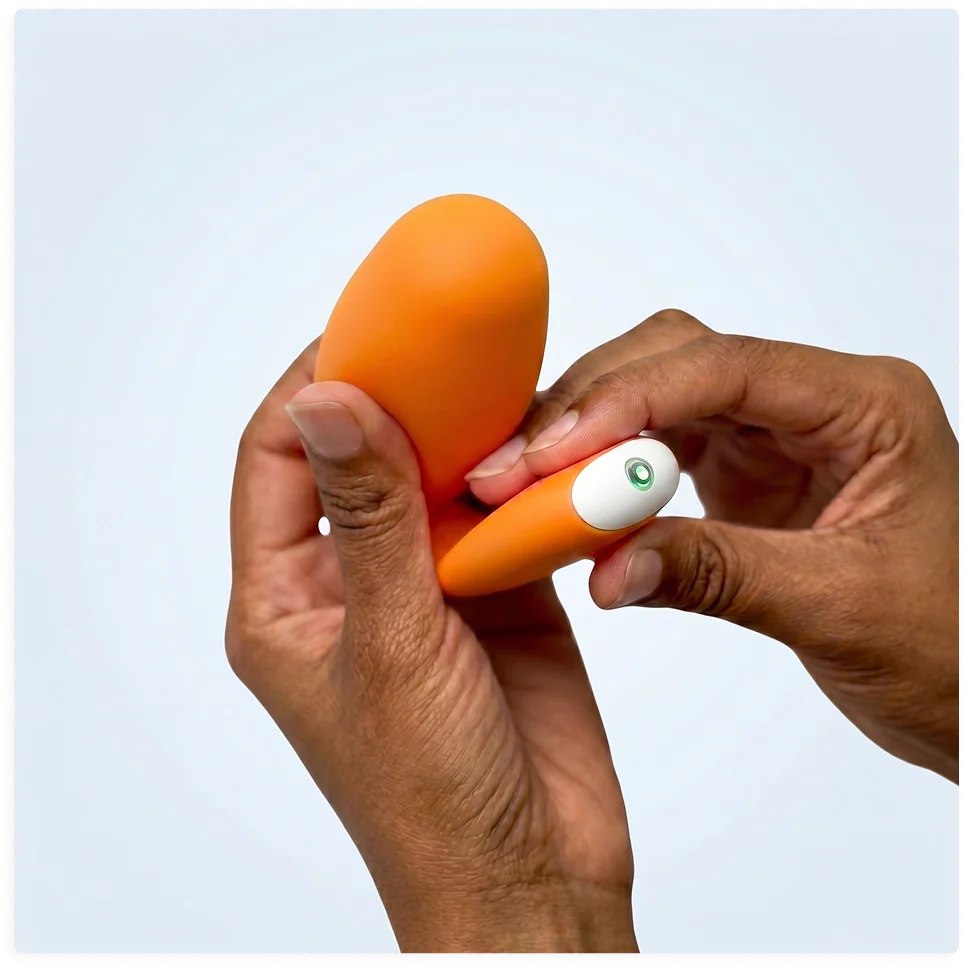Hands holding kGoal IntimFlex with status light on