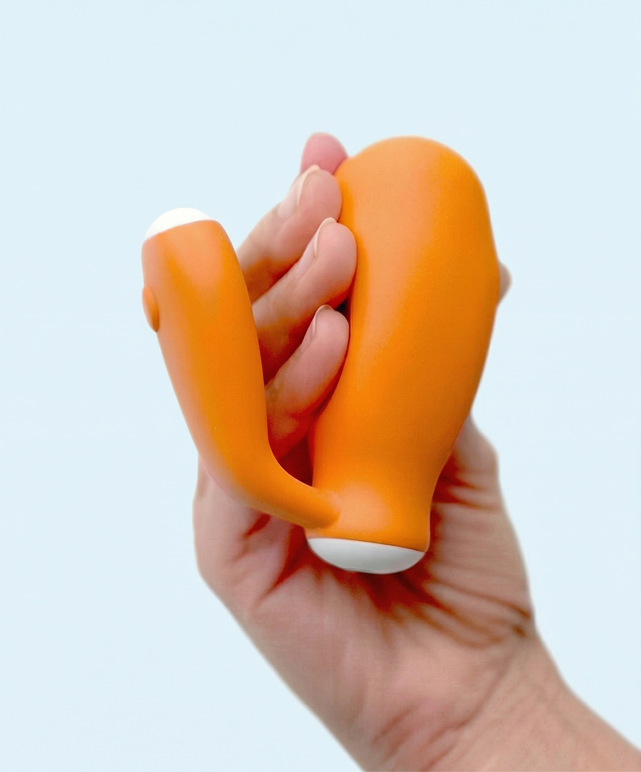 kGoal IntimFlex product being squeezed by the right hand of a woman, demonstrating the soft Squeeze Pillow of the device